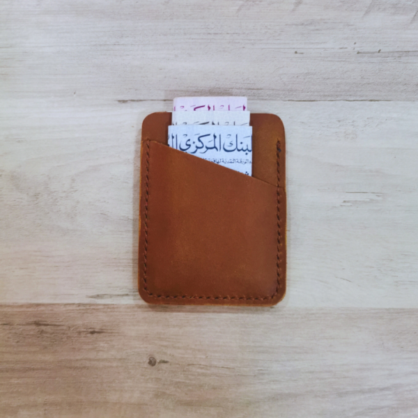 Handmade all-natural leather wallet designed to fit money and cards.