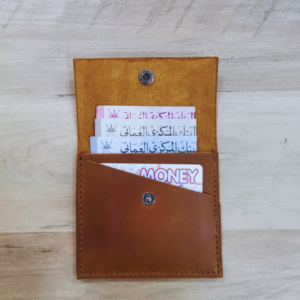Handmade all-natural leather wallet designed to fit money and cards.