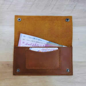 Handmade all-natural leather wallet designed to fit money and cards.