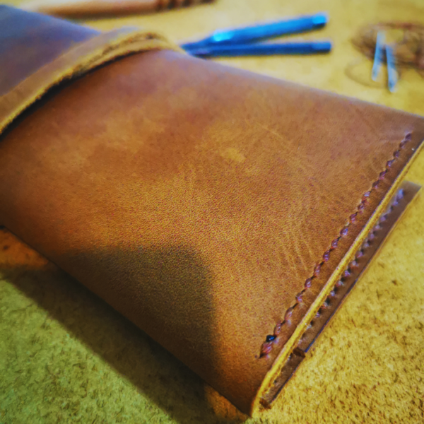 Handmade all-natural leather wallet designed to fit phone, money, and cards.