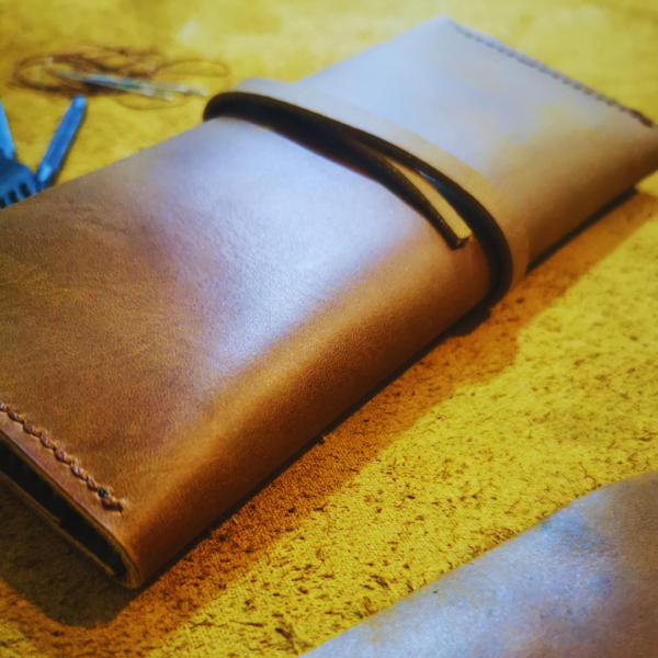 Handmade all-natural leather wallet designed to fit phone, money, and cards.