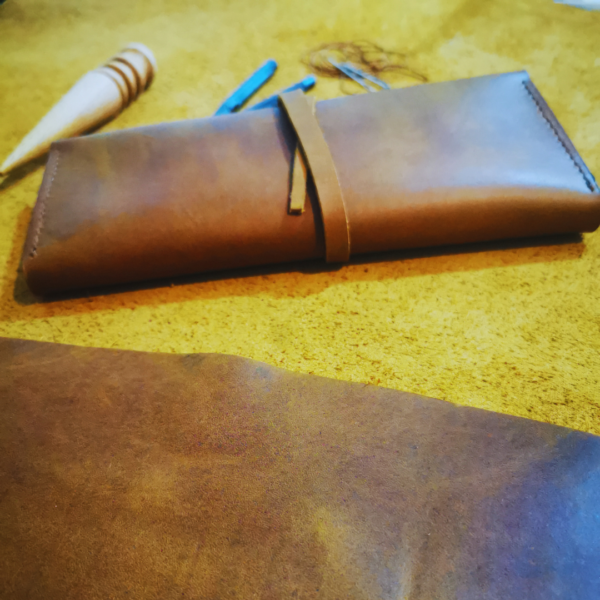 Handmade all-natural leather wallet designed to fit phone, money, and cards.