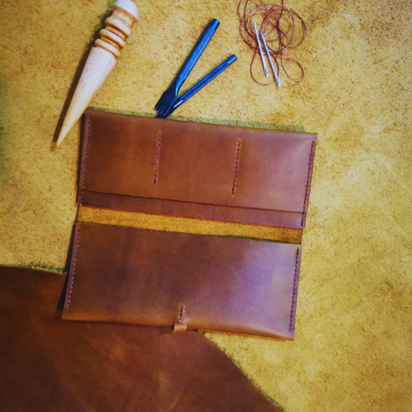 Handmade all-natural leather wallet designed to fit phone, money, and cards.
