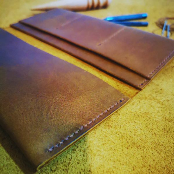 Handmade all-natural leather wallet designed to fit phone, money, and cards.