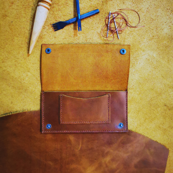 Handmade all-natural leather wallet designed to fit money and cards.