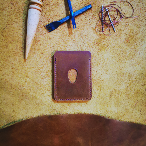 Handmade all-natural leather wallet designed to fit money and cards.