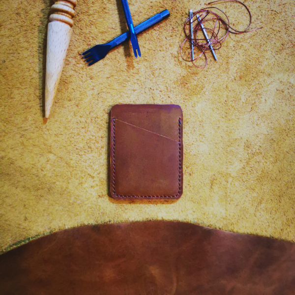 Handmade all-natural leather wallet designed to fit money and cards.