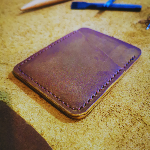 Handmade all-natural leather wallet designed to fit money and cards.
