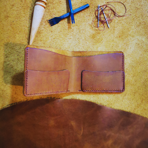 Handmade all-natural leather wallet designed to fit money and cards.