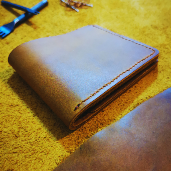 Handmade all-natural leather wallet designed to fit money and cards.