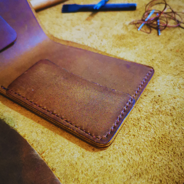Handmade all-natural leather wallet designed to fit money and cards.