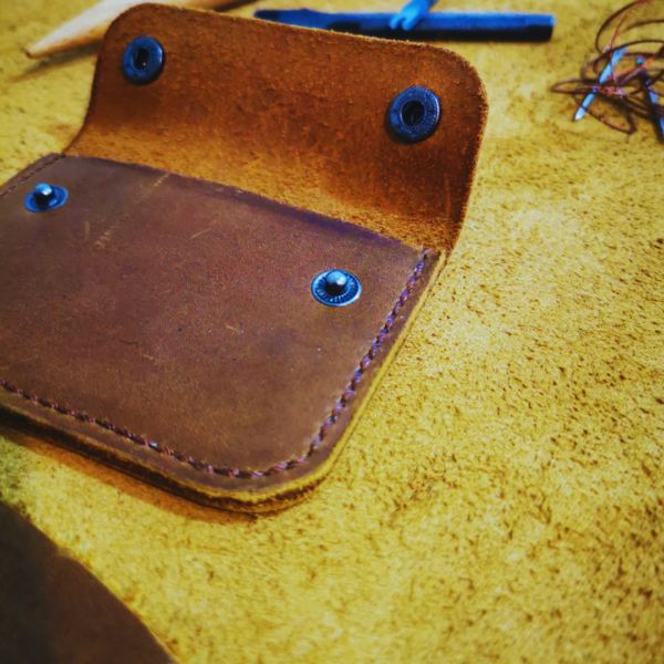 Handmade all-natural leather wallet designed to fit money and cards.