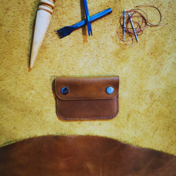 Handmade all-natural leather wallet designed to fit money and cards.