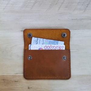 Handmade all-natural leather wallet designed to fit money and cards.