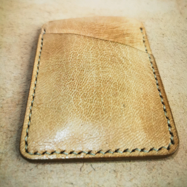 Handmade all-natural leather wallet designed to fit money and cards.