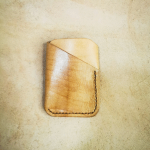 Handmade all-natural leather wallet designed to fit money and cards.