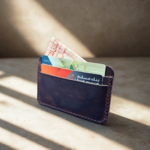 Minimal luxury background for a handmade navy blue leather wallet, soft natural light, warm beige or grey tones, subtle shadows, clean studio look. stay consistent to backgrounds generated before.