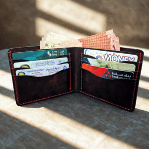 Handcrafted dark red crazy horse leather bifold wallet with natural finish and matching stitching.